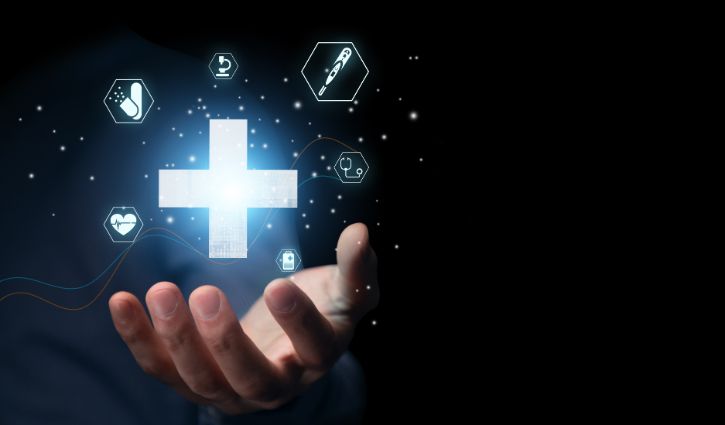 A hand is outstretched against a dark background, with glowing medical icons floating above it, representing strategies for enhancing employee health. Among them are a prominent cross and symbols like a pill, heart, cup, syringe, and medical chart.