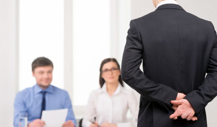 Close up of man back with fingers crossed behind. Idea of lying on job interview