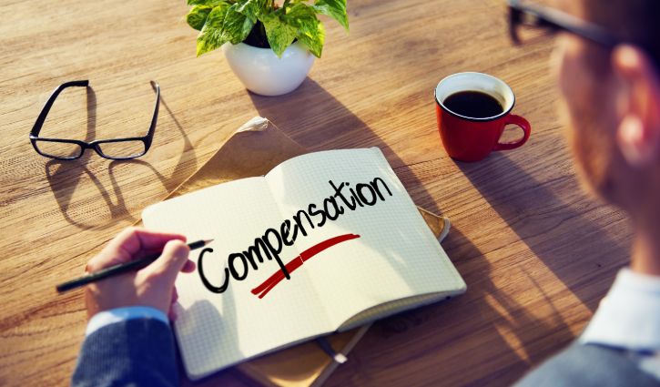 Man with a Note and a Single Word Compensation