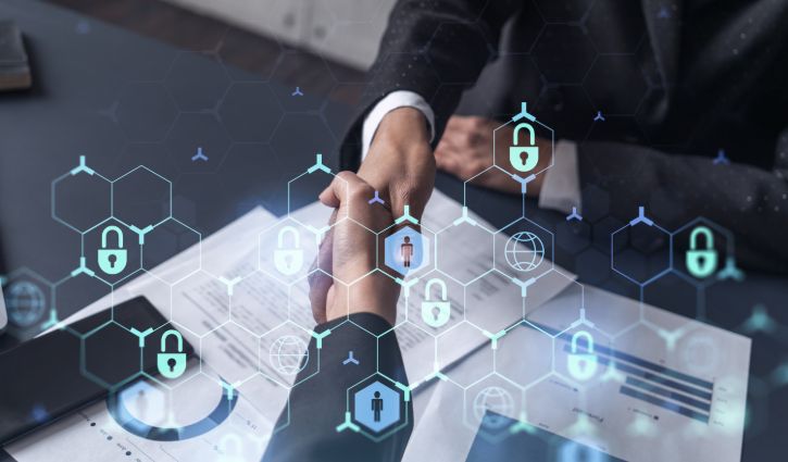 Handshake of two businesswomen who enters into the contract to protect cyber security of international company. Padlock Hologram icons over the table with documents.