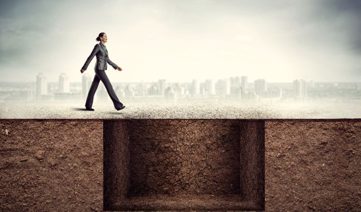 Businesswoman going to the trap or pitfall