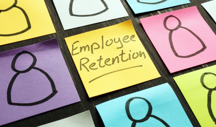 Employee retention sign and figurines on the memo sticks.