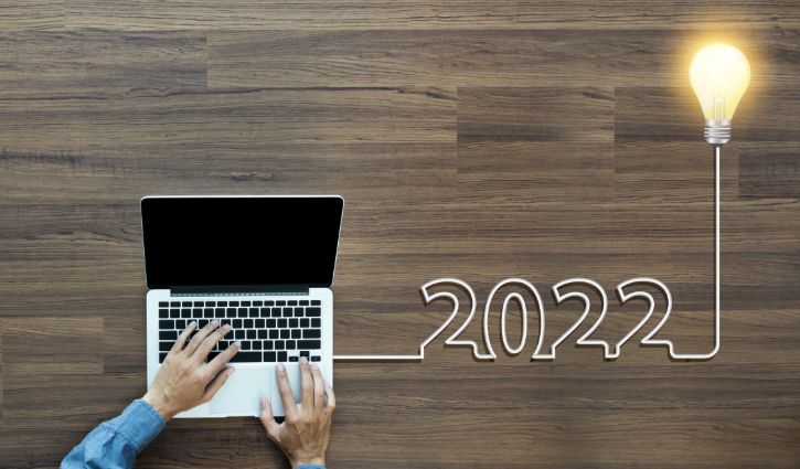 5 HR Technology Trends to Monitor in 2022 2 Creative light bulb idea 2022 new year, With businessman working on laptop computer PC, Top view from above