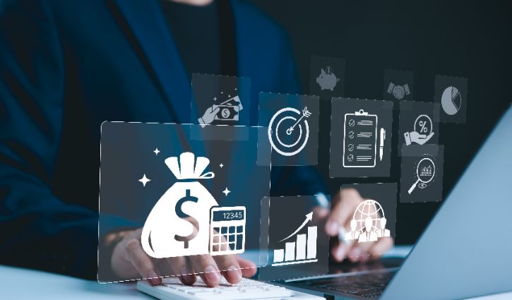 A person in a suit types on a laptop with floating financial icons, symbolizing financial planning and analysis, as benchmarking insights help turn data to dollars for higher profits.