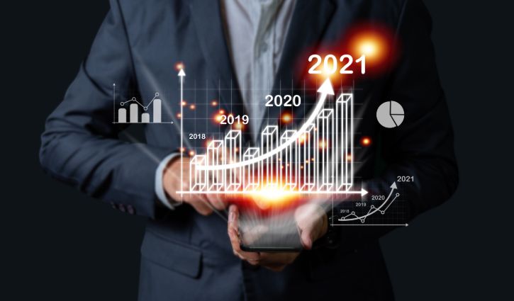 Businessman investor man hand holding trend chart growing up from 2020 to 2021, Business investment growth up concept.