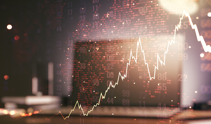 A glowing, jagged stock market graph overlays a blurred background with bokeh lights and numerical data. The line sharply ascends and descends, mirroring the IT staffing markets fluctuations.